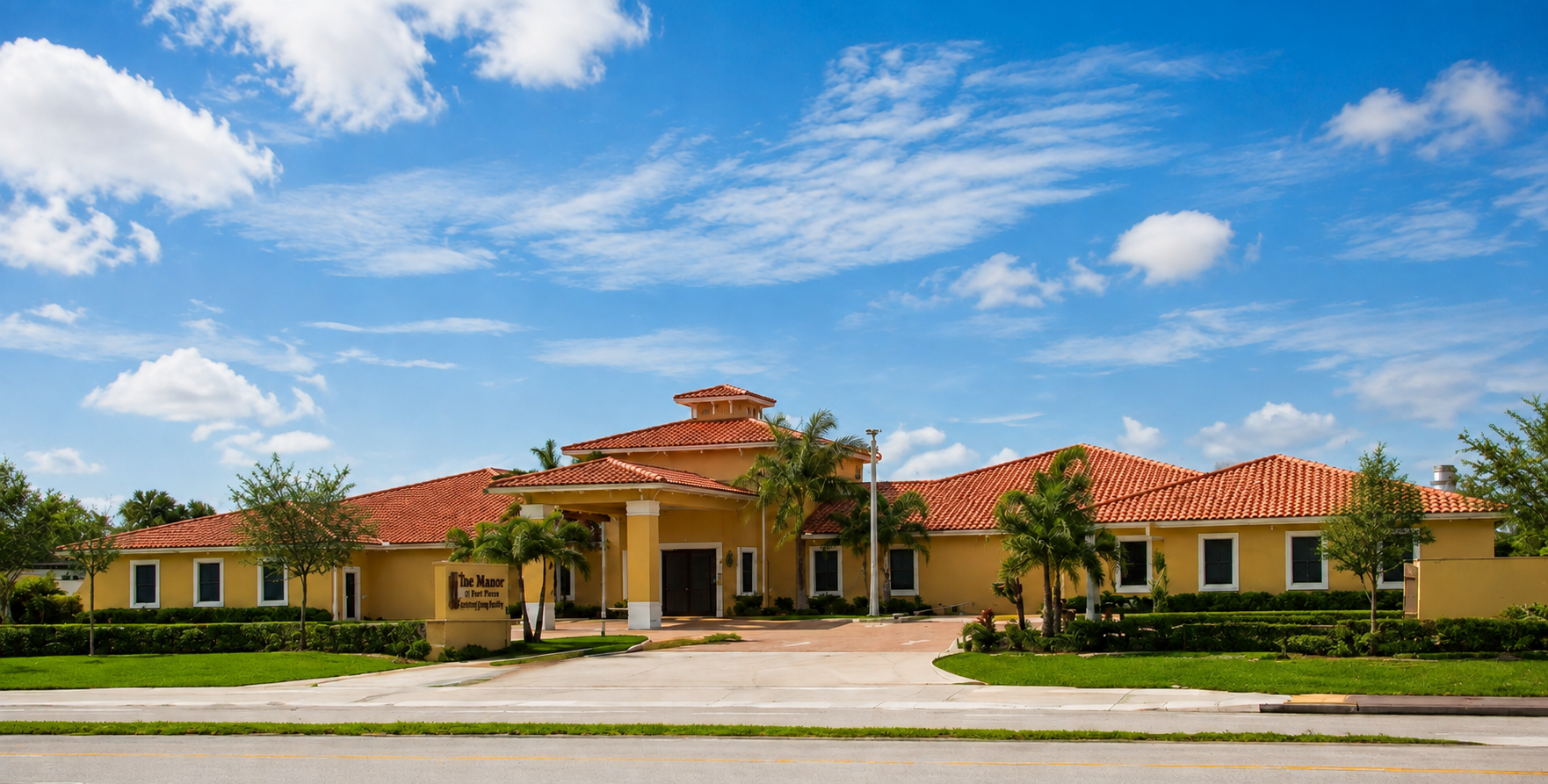 Wide front view of The Manor of Fort Pierce memory care community